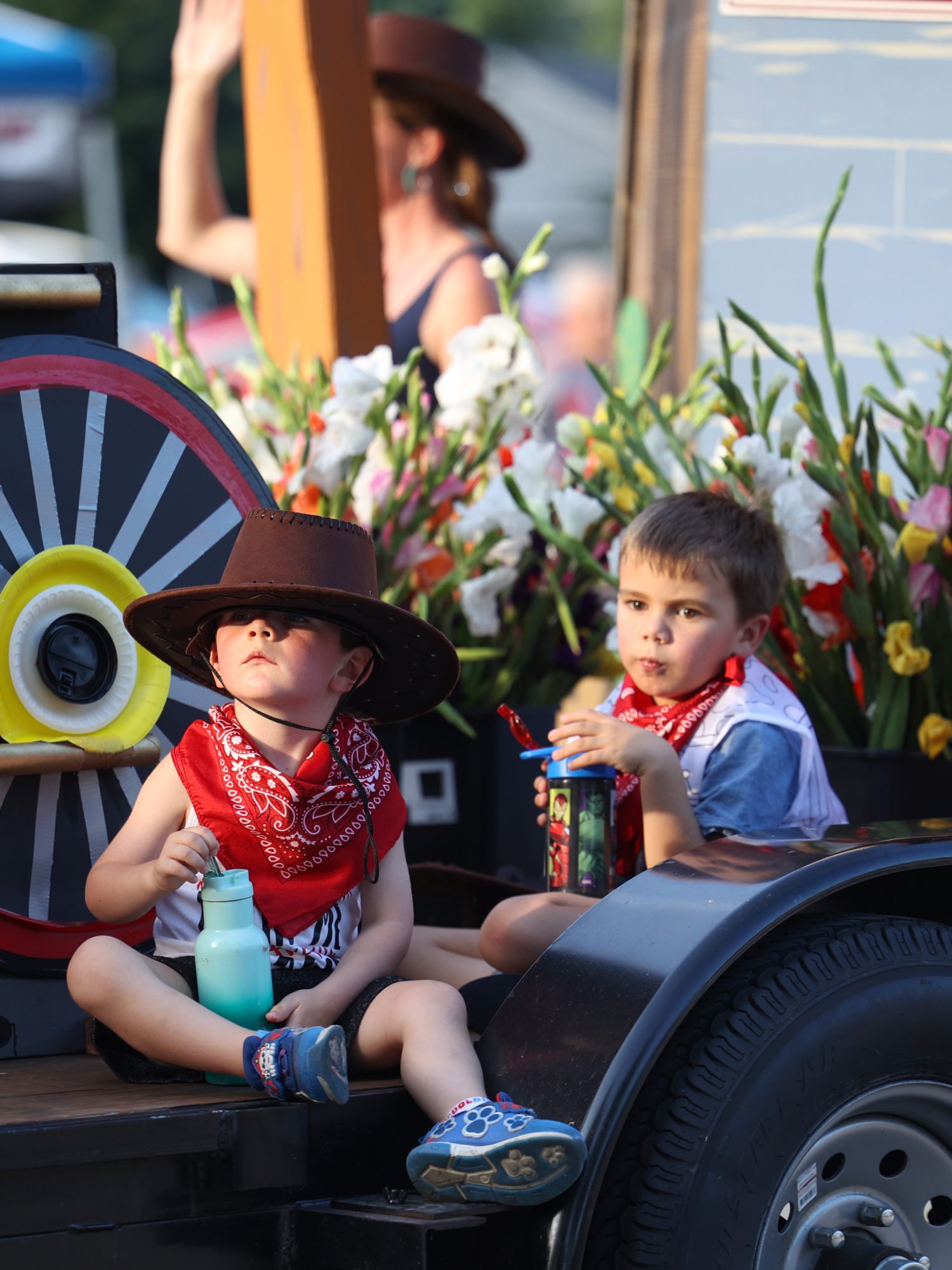 Children in cowboy hats ride a gladiolus-decked float in the Momence Gladiolus Festival parade