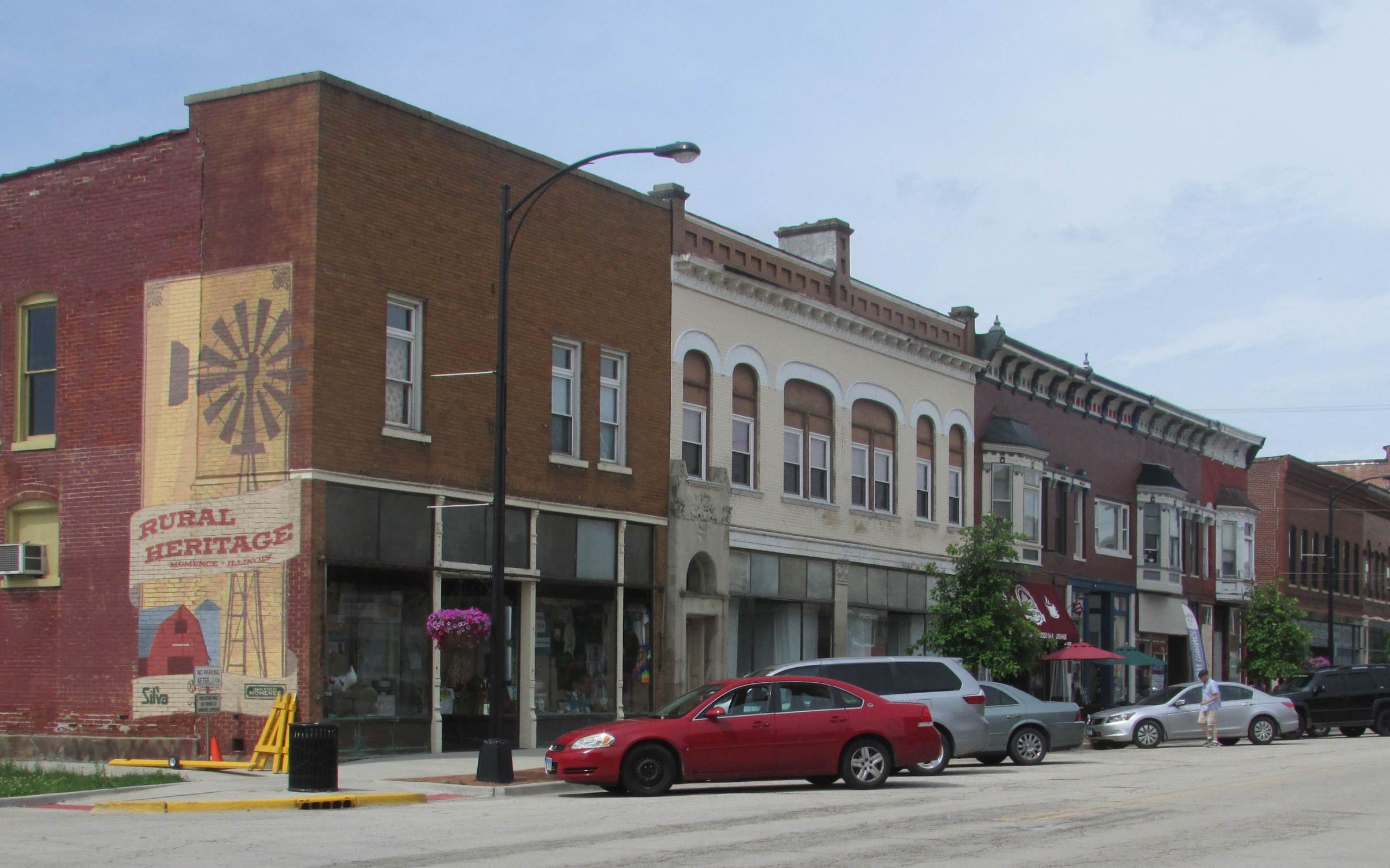 The same downtown blocks of Momence today, with the Rural Heritage mural